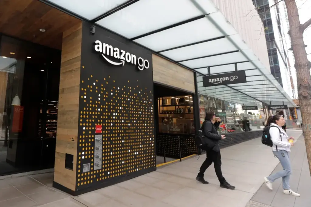 Amazon Go storefront entrance with shoppers walking outside the Amazon store front set up.
