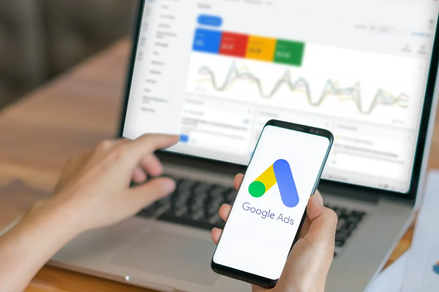 Google Ads dashboard on laptop and phone