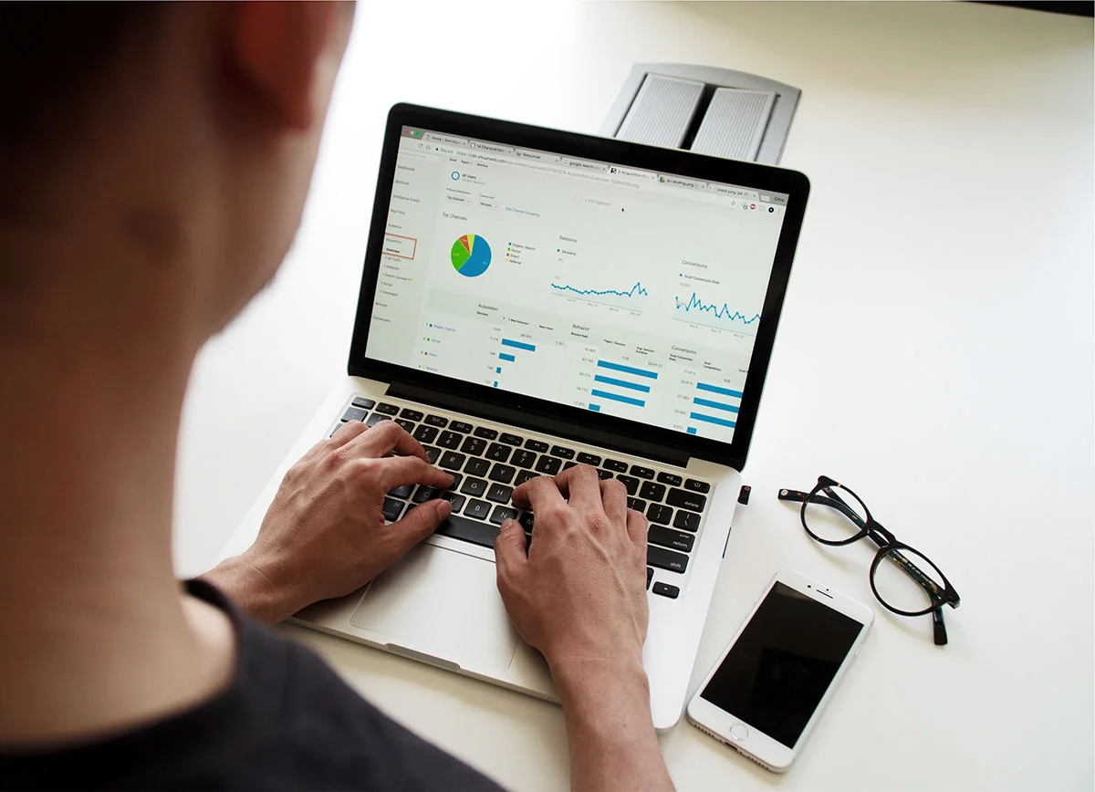 Person analyzing performance data on a laptop.