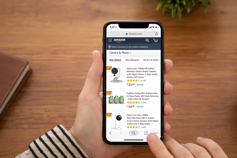 Shopper browsing Amazon product rankings and listings on a smartphone.