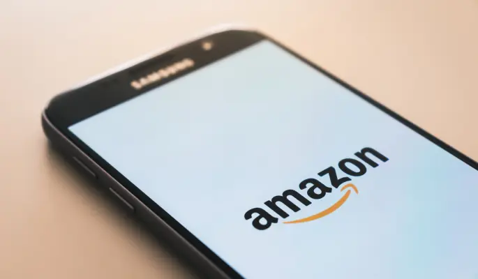 Smartphone displaying the Amazon logo on its screen.